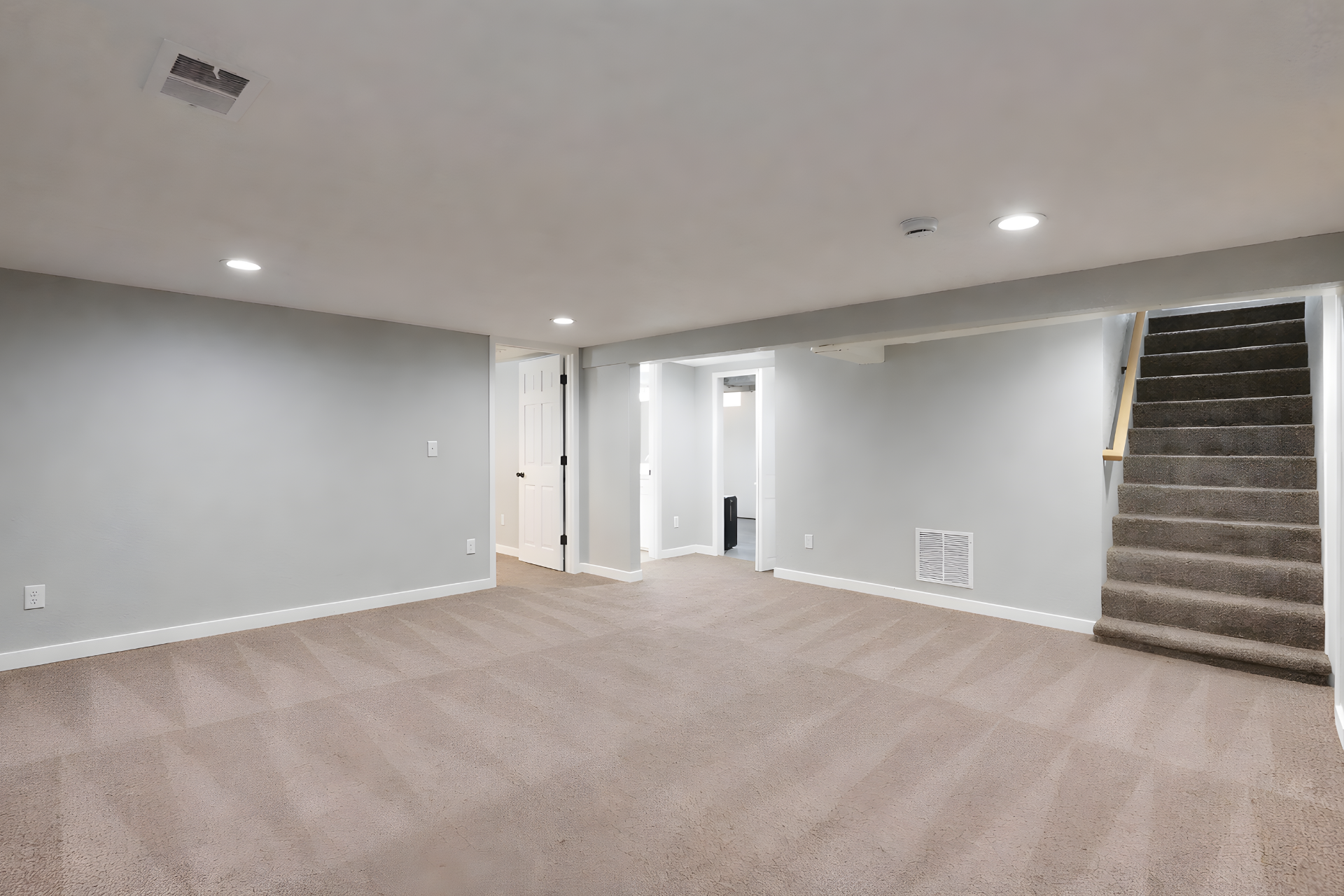 Hand in yellow glove wiping a white surface with a blue cleaning cloth.