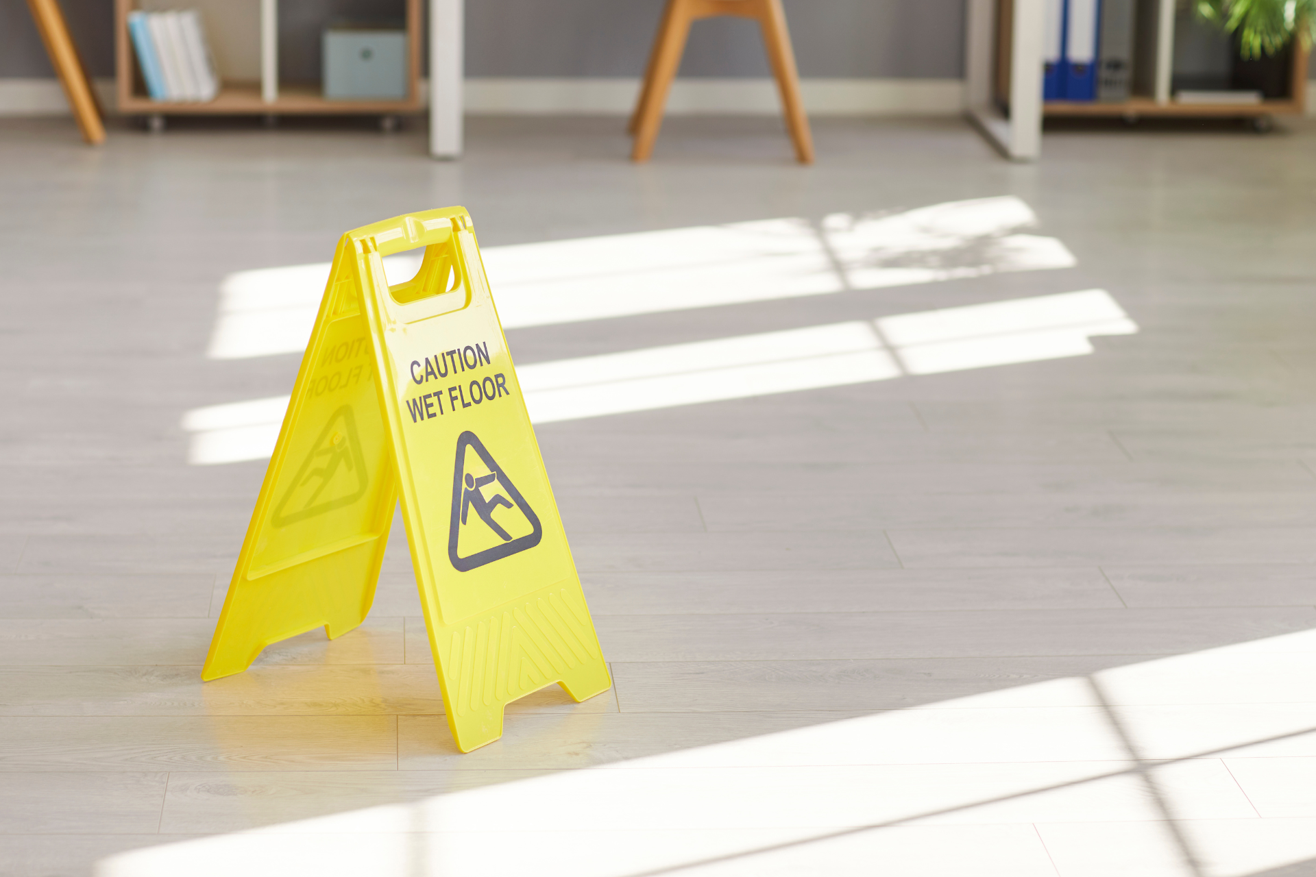 Glass windows reflect greenery from outside, with metal frame.