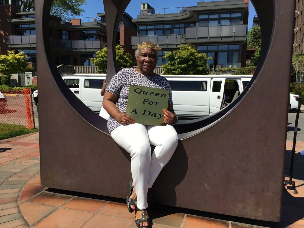 A woman is sitting in a circle holding a sign that says