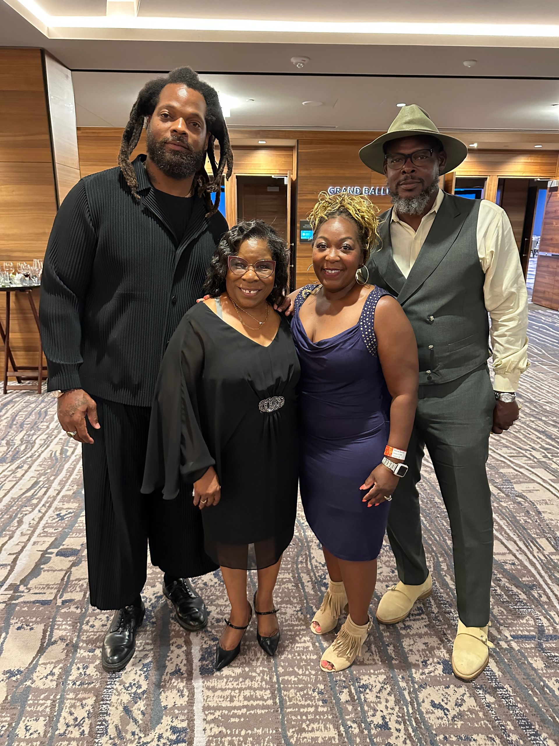 A group of people are posing for a picture together in a room.