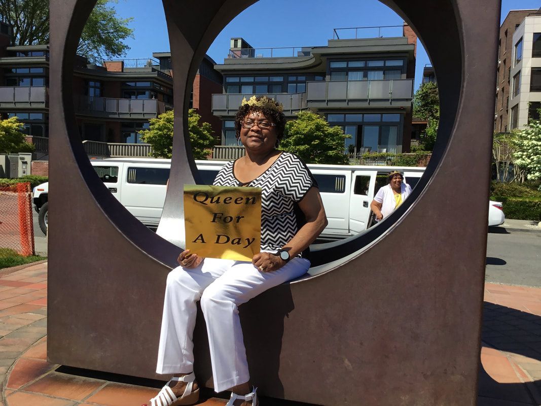 A woman is sitting in a circle holding a sign that says