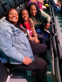 A group of people are sitting in a stadium.
