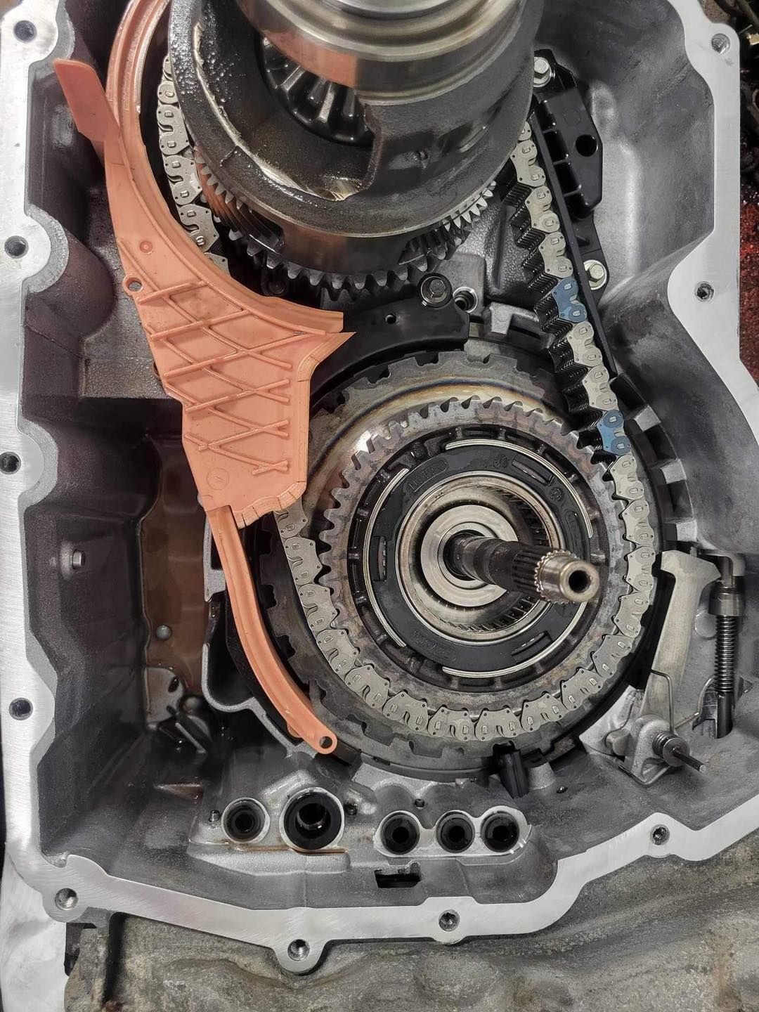 A close up of a gearbox with a chain attached to it