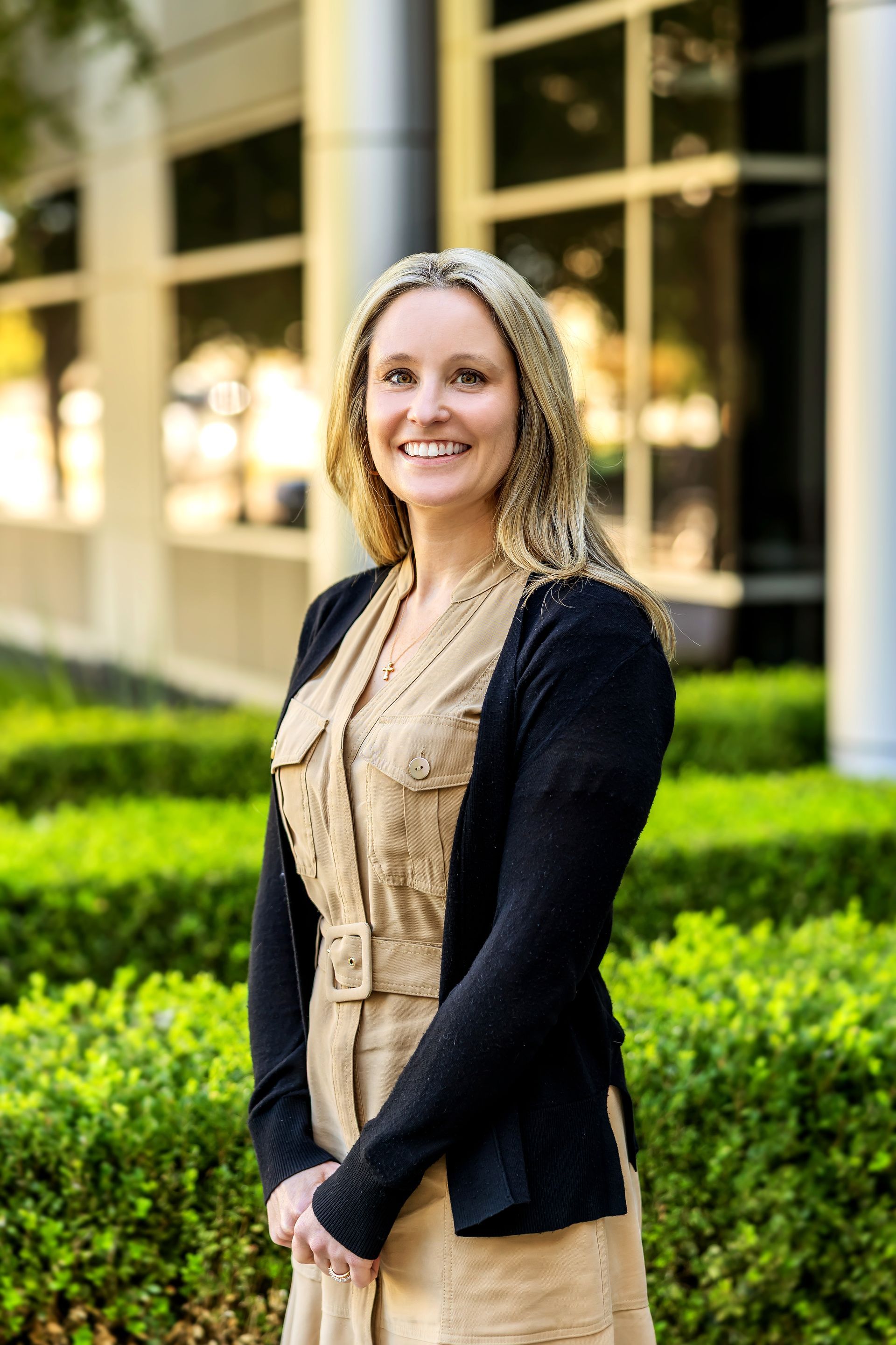 A woman in a blue jacket is smiling for the camera.