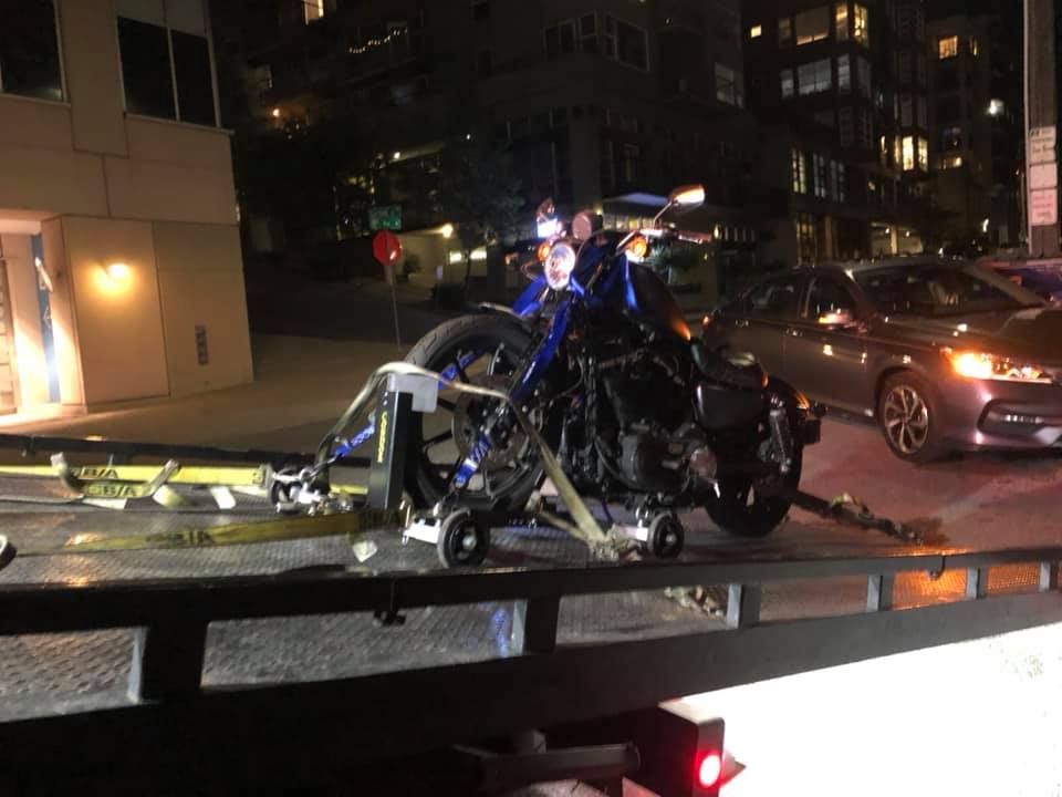 A motorcycle is being towed by a tow truck.