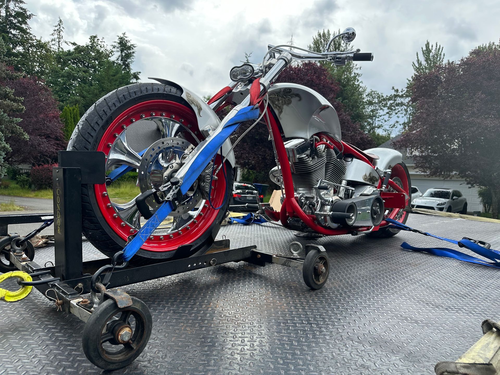 A motorcycle is sitting on top of a tow truck.