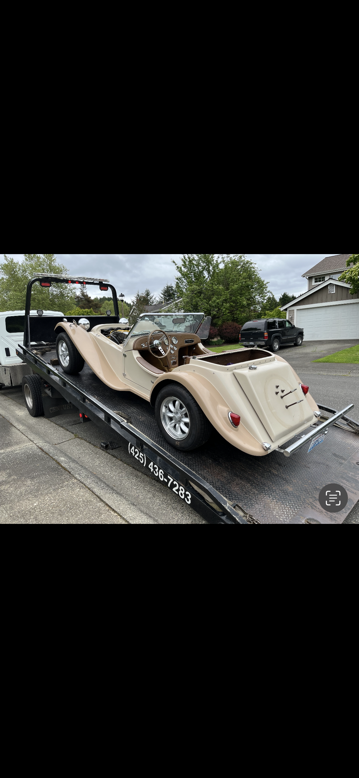 A car is being towed by a tow truck.