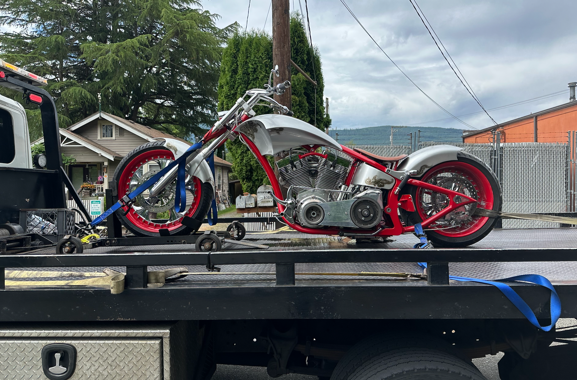 A motorcycle is sitting on top of a tow truck.