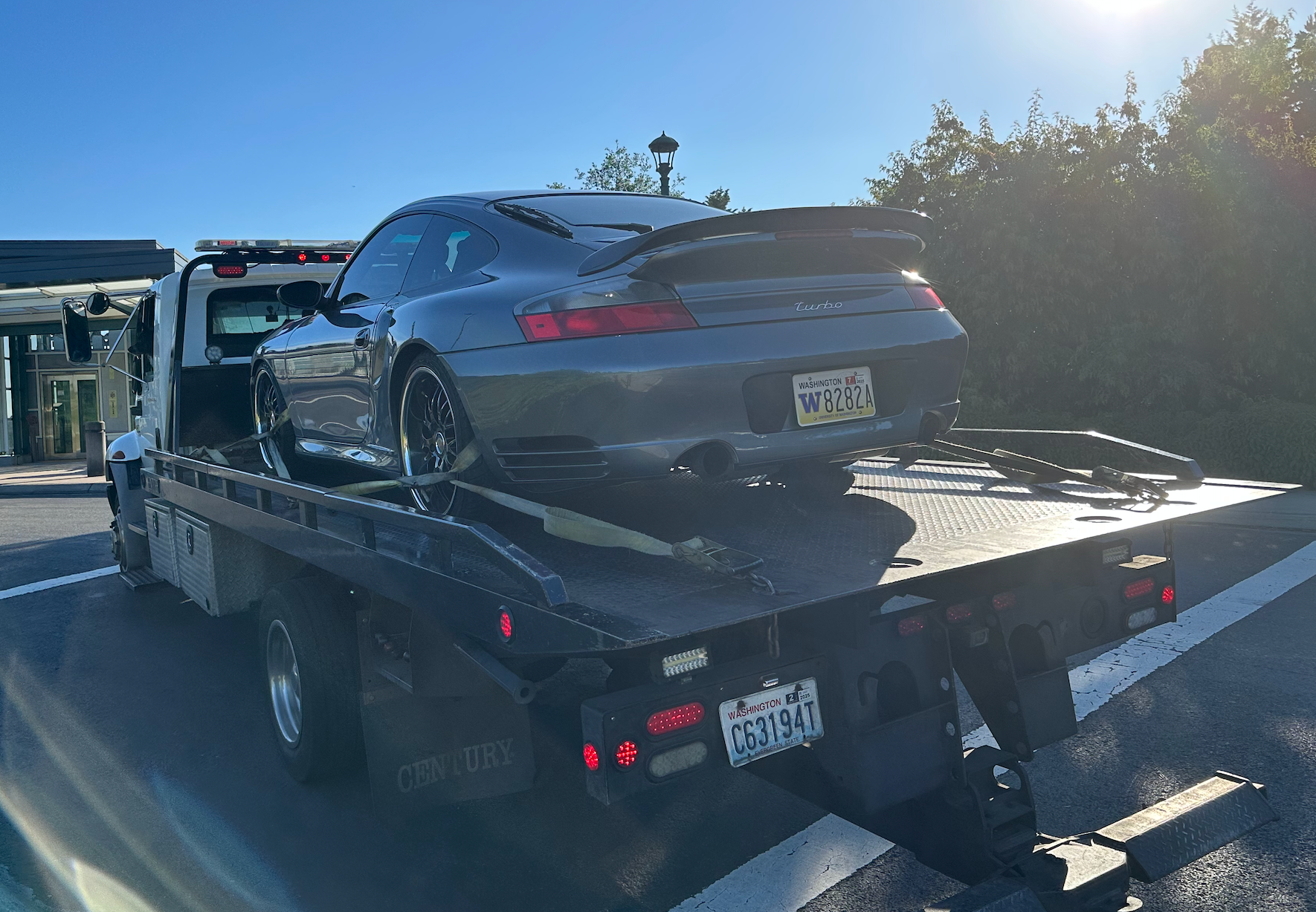 A car is sitting on top of a tow truck.