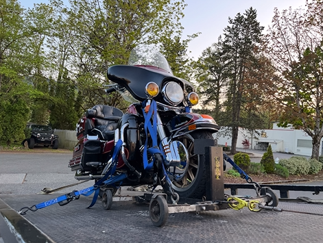 A motorcycle is being towed by a tow truck.