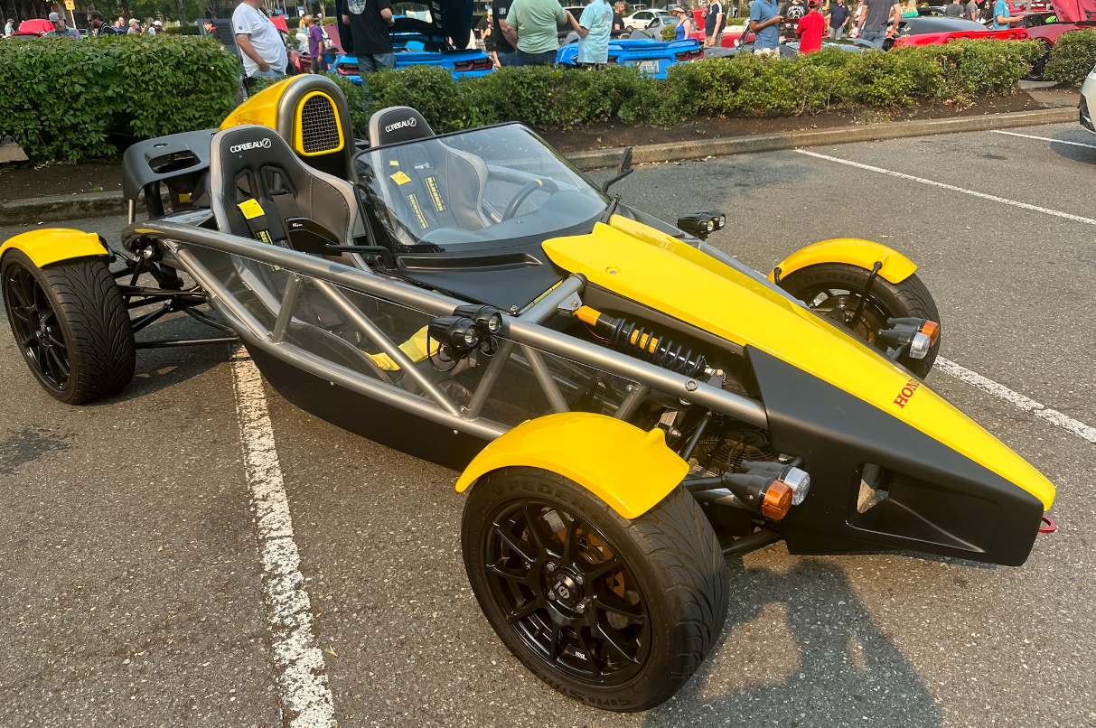 A yellow and black sports car is parked in a parking lot.