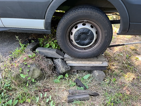 A van is sitting on top of a pile of rocks.