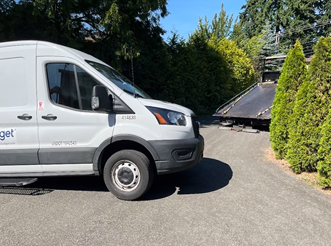 A white van is parked on the side of the road.