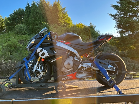 A motorcycle is sitting on top of a trailer.