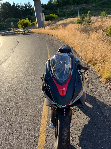 A black motorcycle is parked on the side of a road