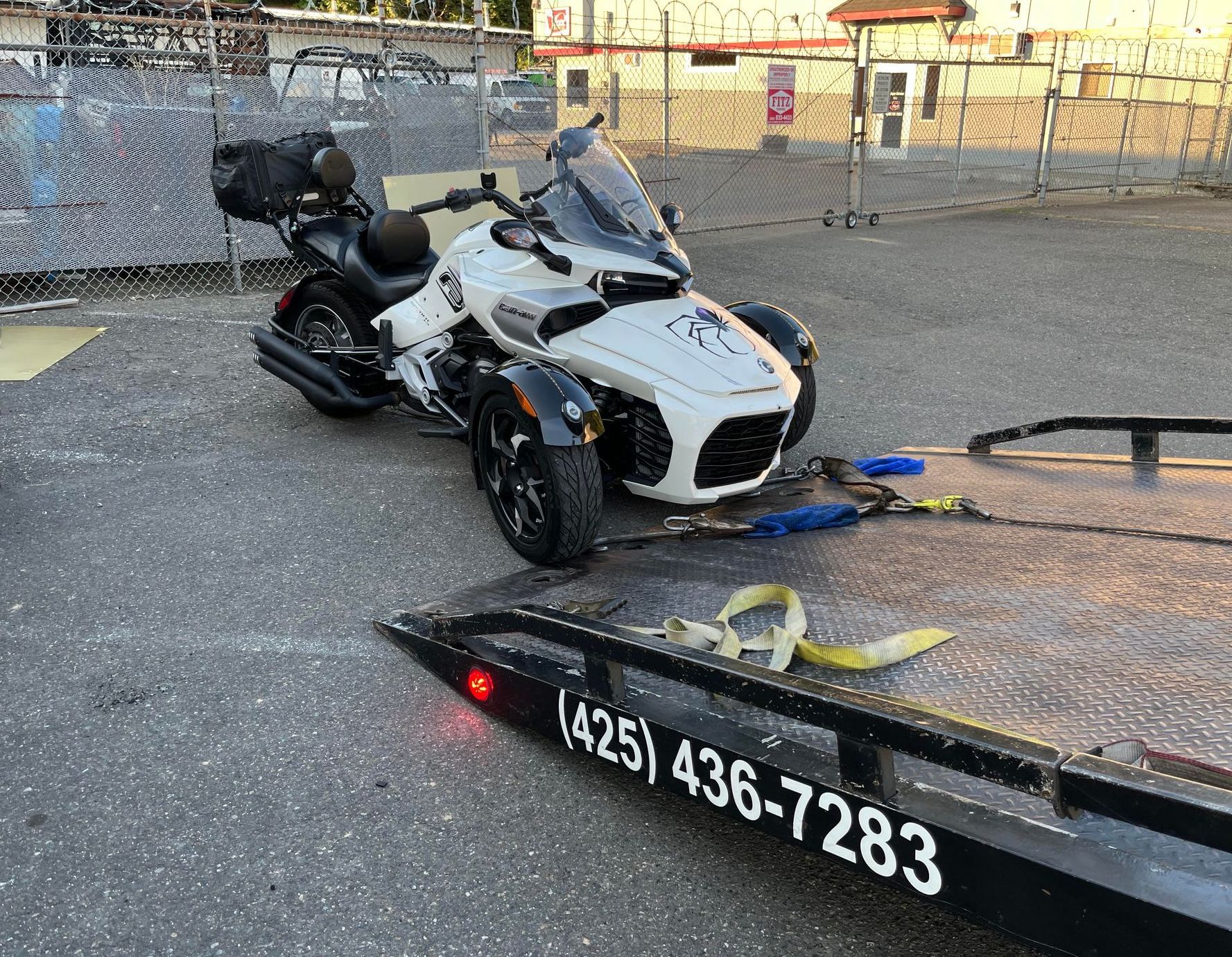 A motorcycle is sitting on top of a tow truck.