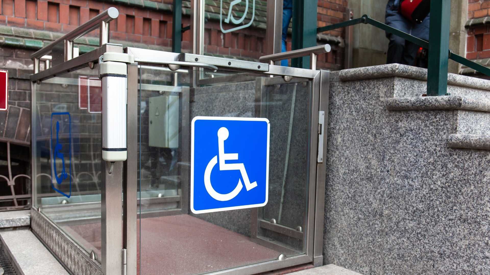 A glass door with a handicap sign on it.