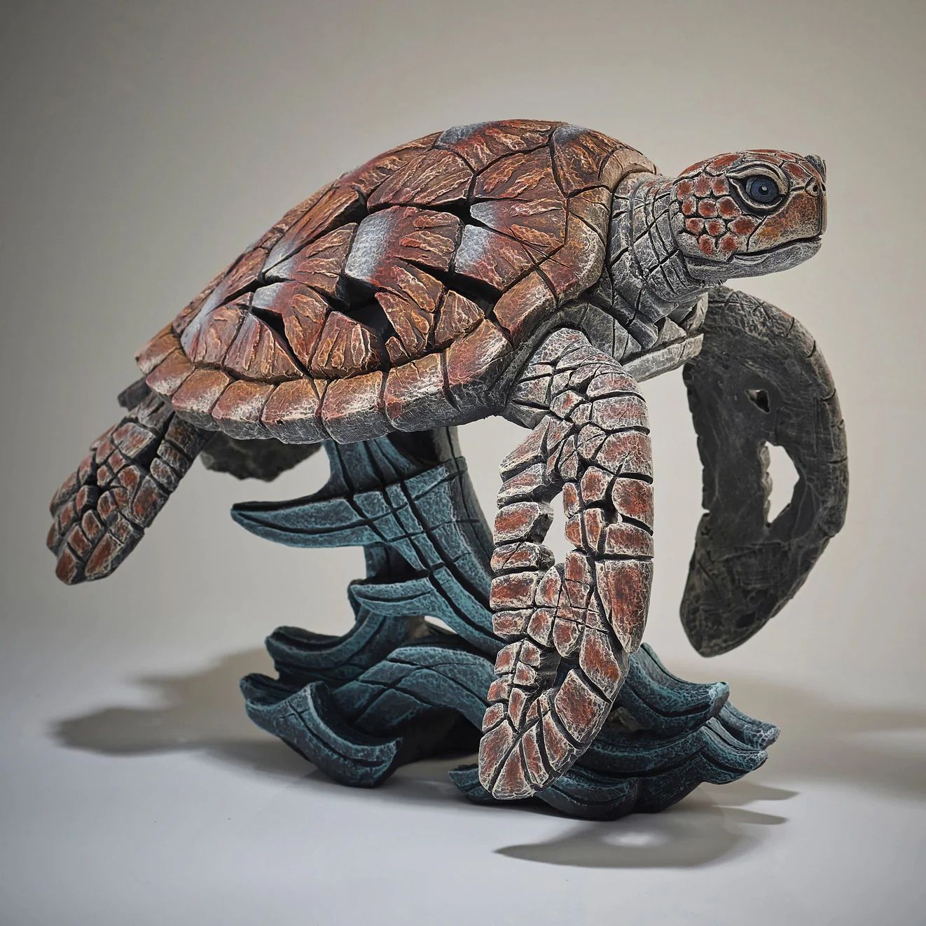 Edge Sculpture - a statue of a sea turtle sitting on a rock