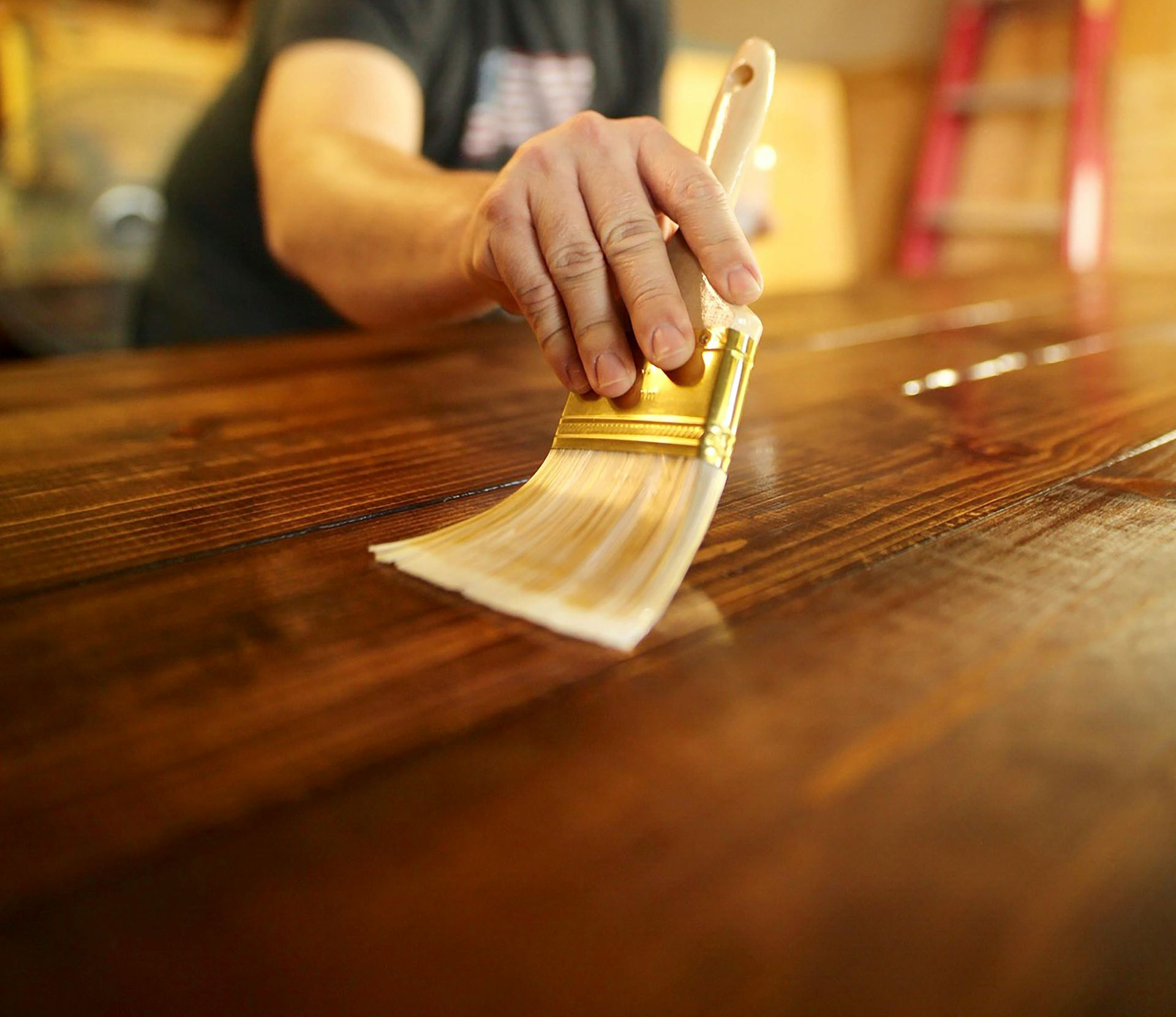 A man is installing cabinets in a kitchen.