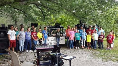 Harmony Hill Music having a music lesson outside.