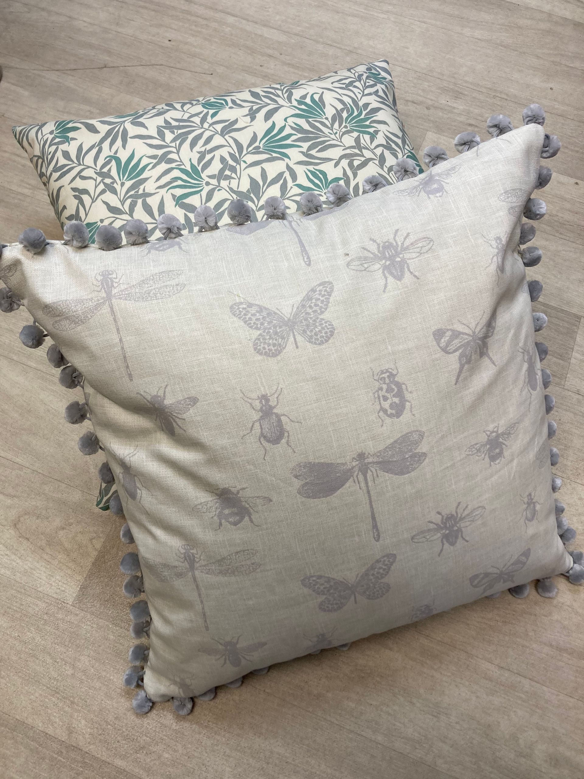 Three colorful pillows are stacked on top of each other
