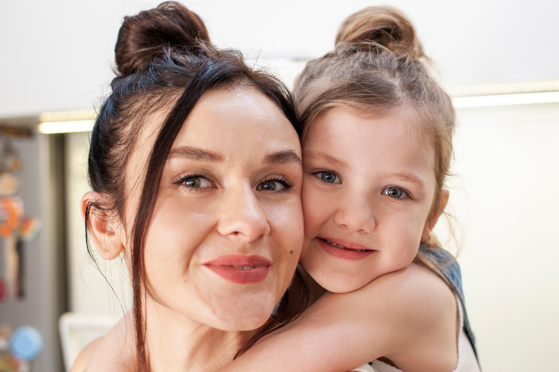 A woman is holding a little girl in her arms.