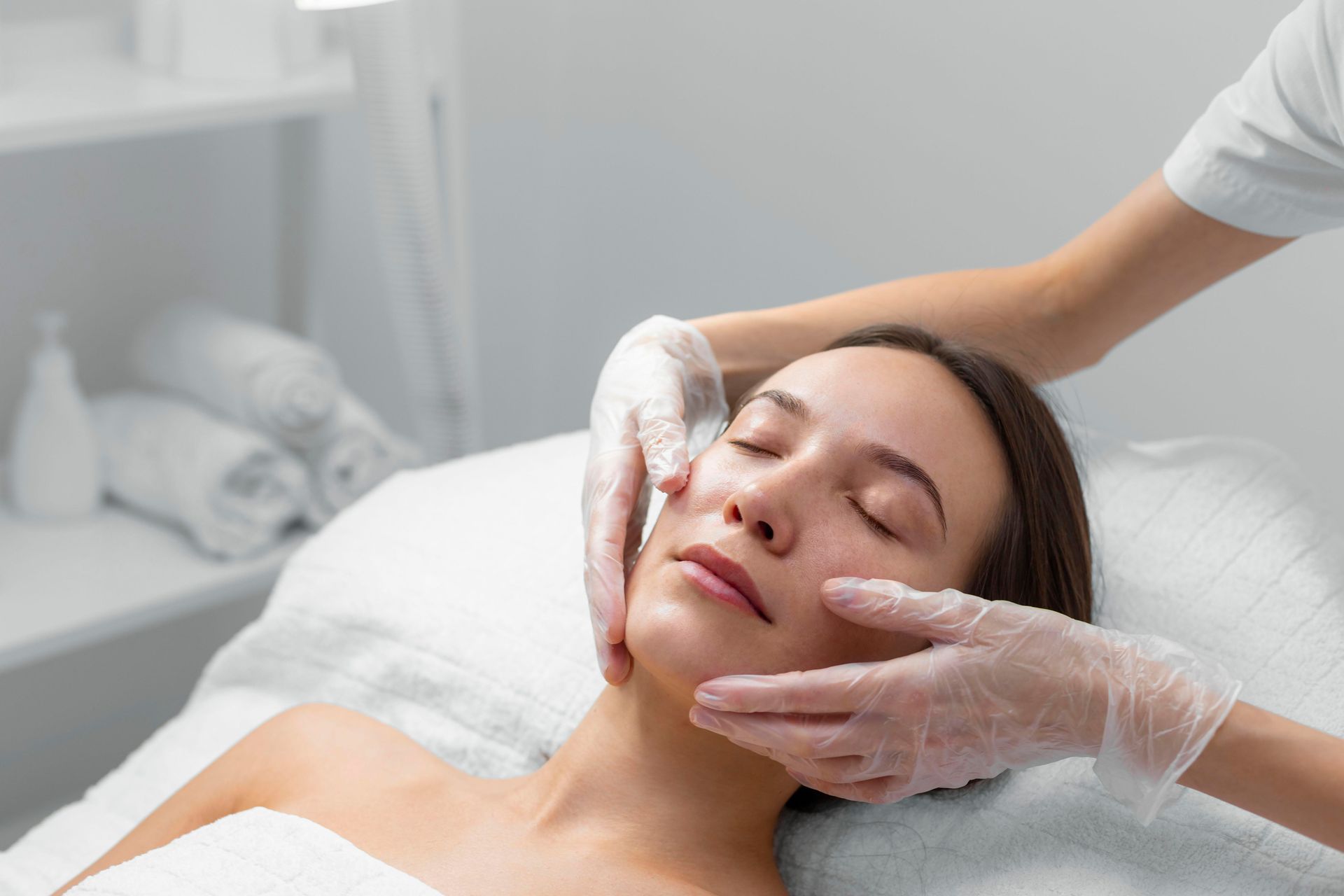 A woman is getting a facial treatment at a spa.
