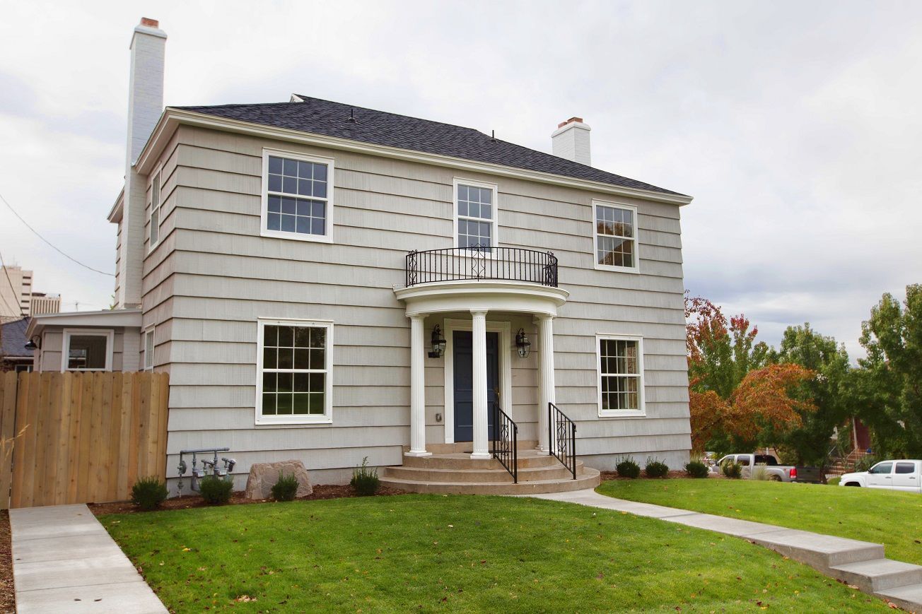 a city skyline with mountains in the background and train tracks in the foreground. Click to go to Single Family page