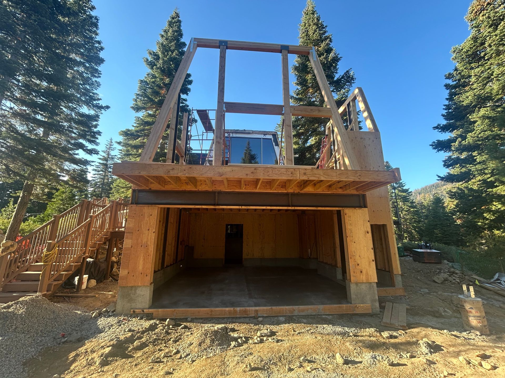 New construction of a roof, brick-colored tiles, over a wooden-framed building with scaffolding, outdoor setting.