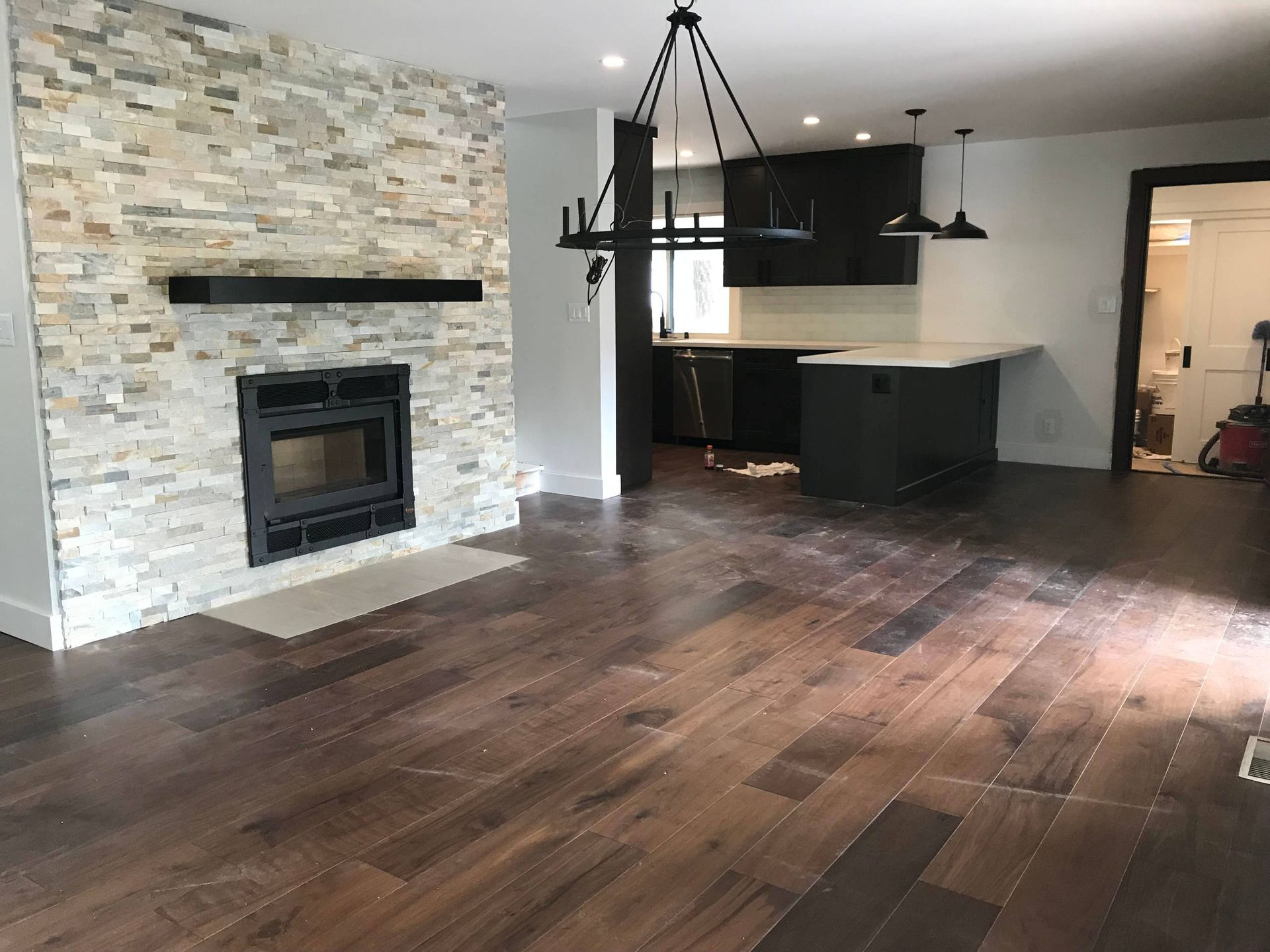 A lush green lawn with a border of flowers and shrubs