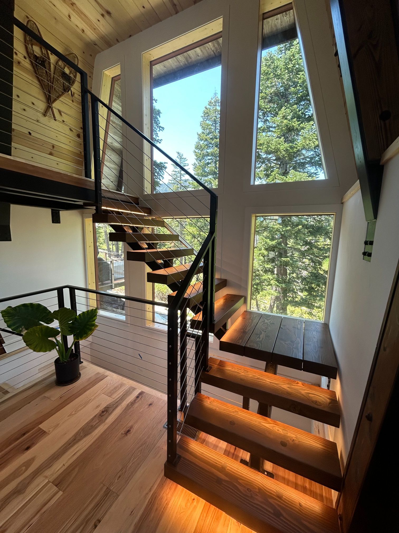 A ladder and paint buckets are sitting on the floor in a room.