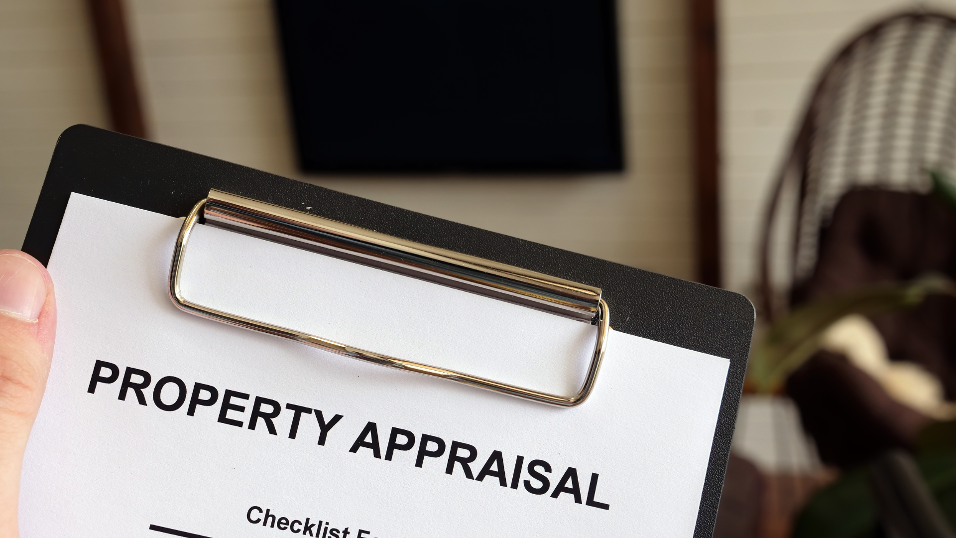 A person is holding a clipboard with a property appraisal on it.