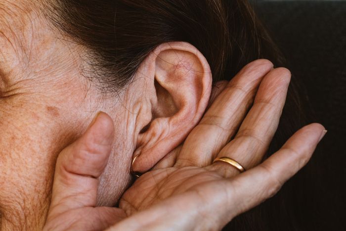 Senior Woman Holding Her Ear — Sewell, NJ — Hearing Hut LLC