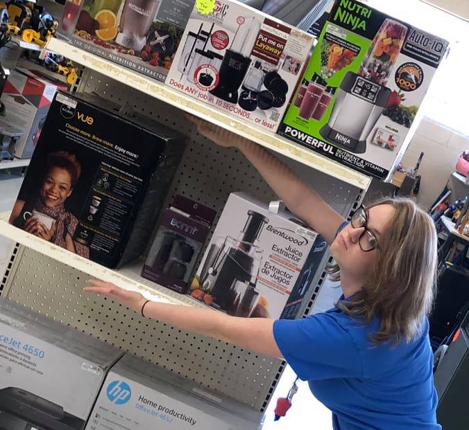 Woman Employee Wearing Blue Uniform — Baton Rouge, LA — American Pawn