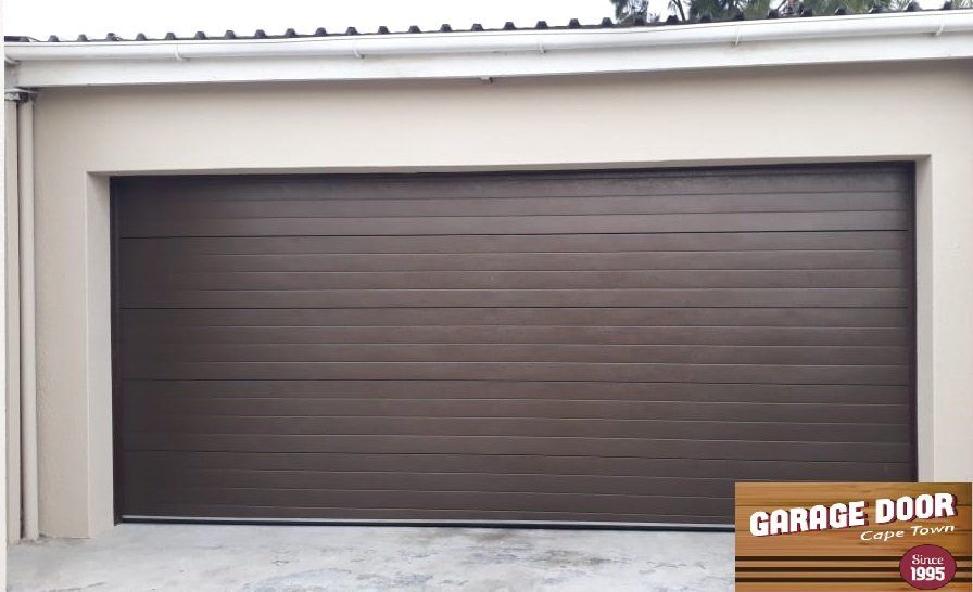 Brown horizontal-slat garage door in a neutral-colored frame.