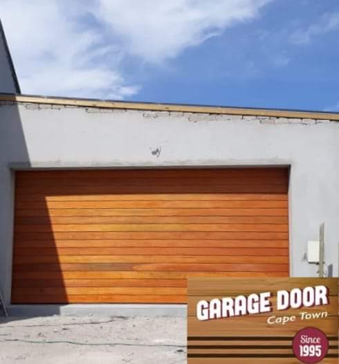 Wooden garage door on a white building, Cape Town.