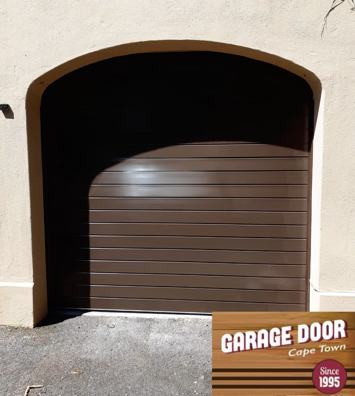 Brown garage door with arched top, Cape Town.
