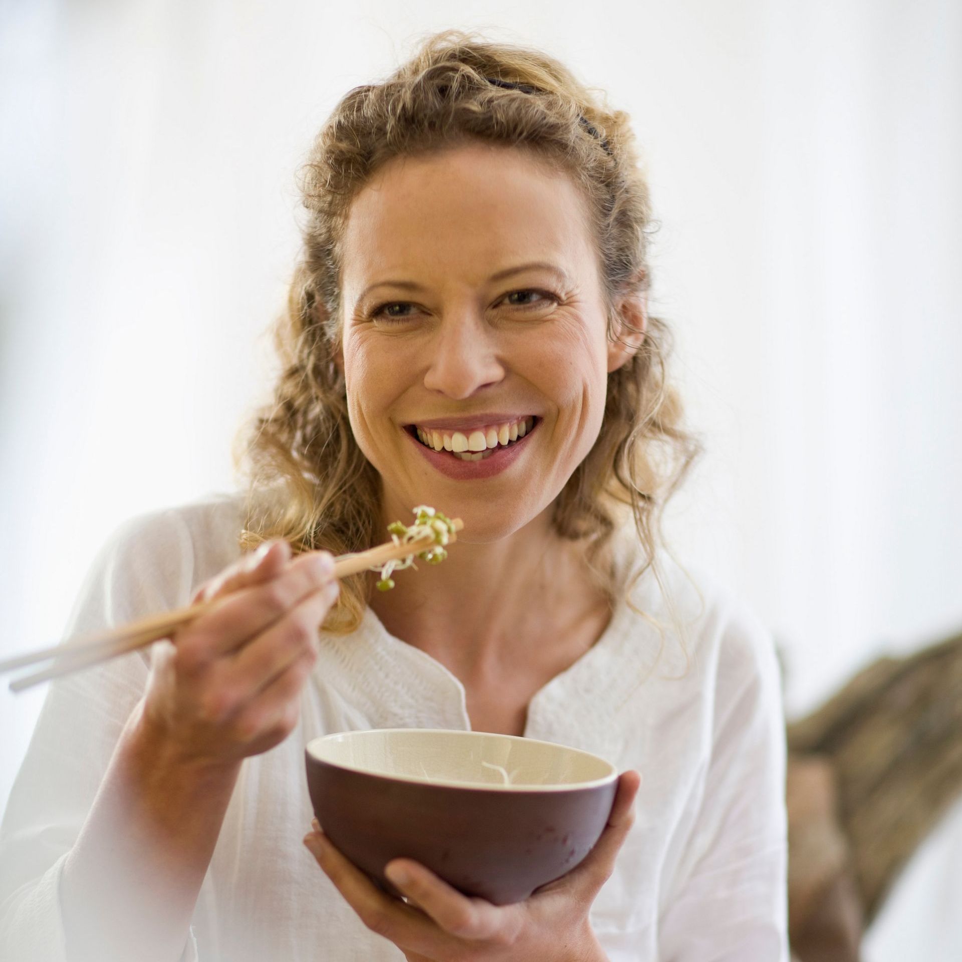 middle aged woman eating healthy meal
