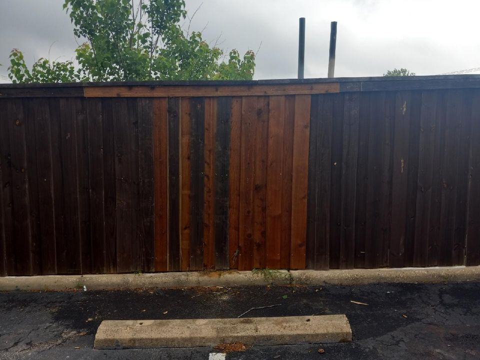 Man Installing fence picket by picket