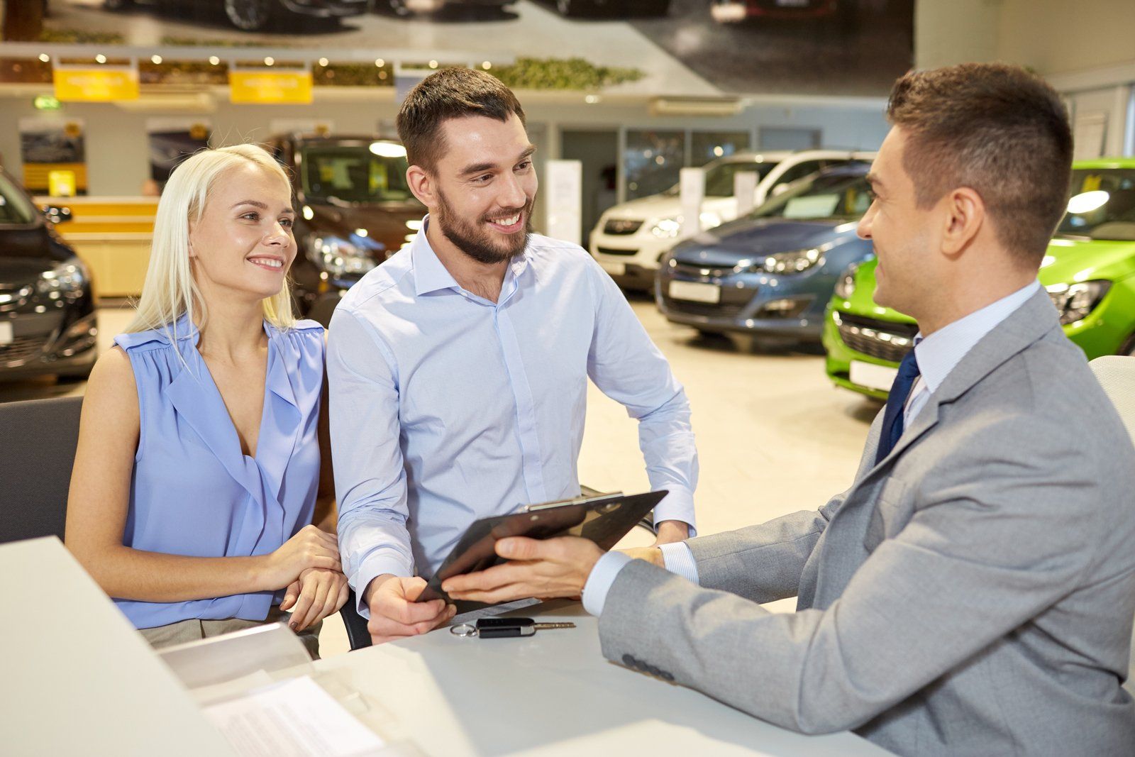Car Finance Broker showing clients paperwork for new car loan