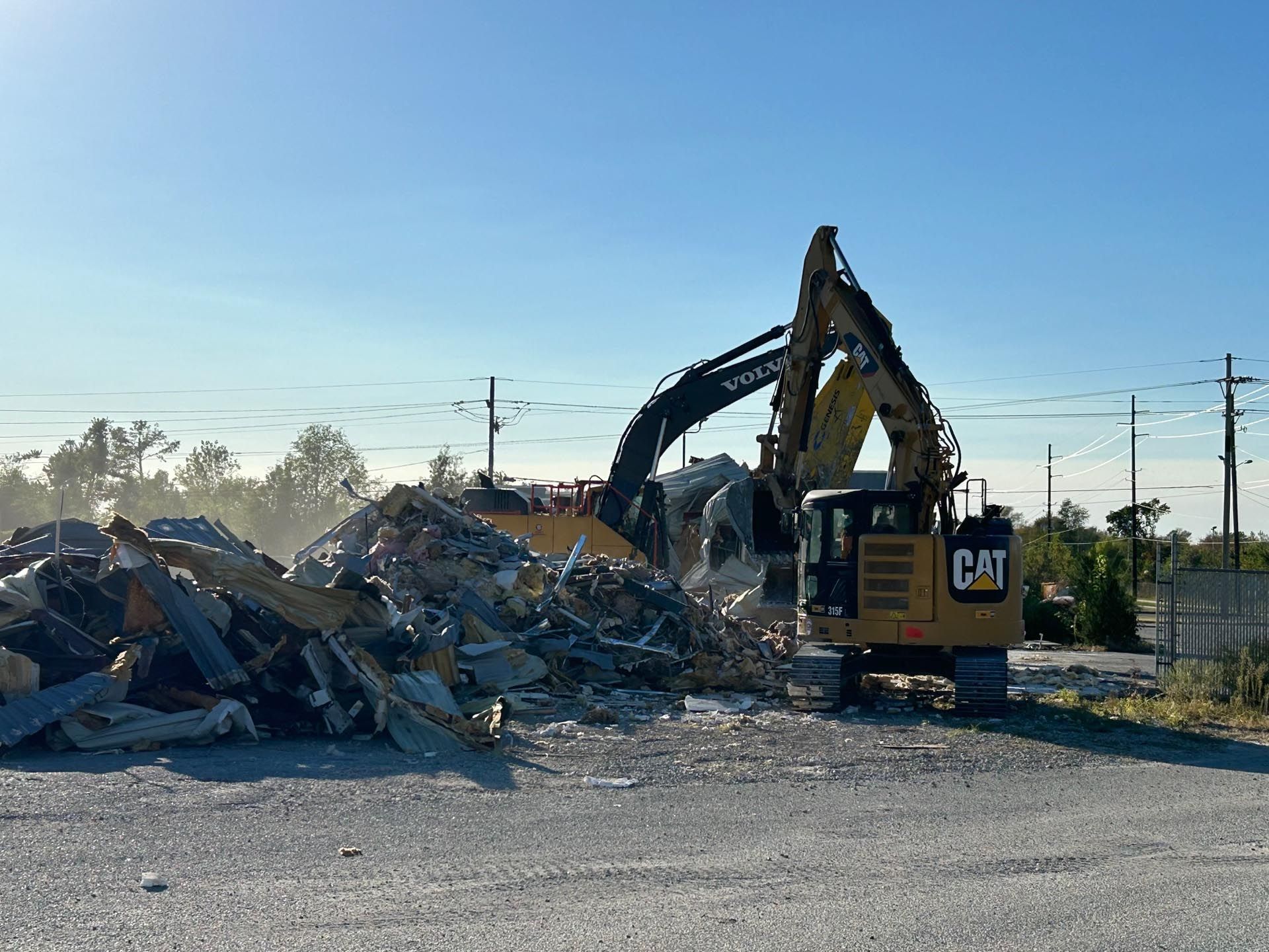 A yellow wheel loader is parked in a dirt field.