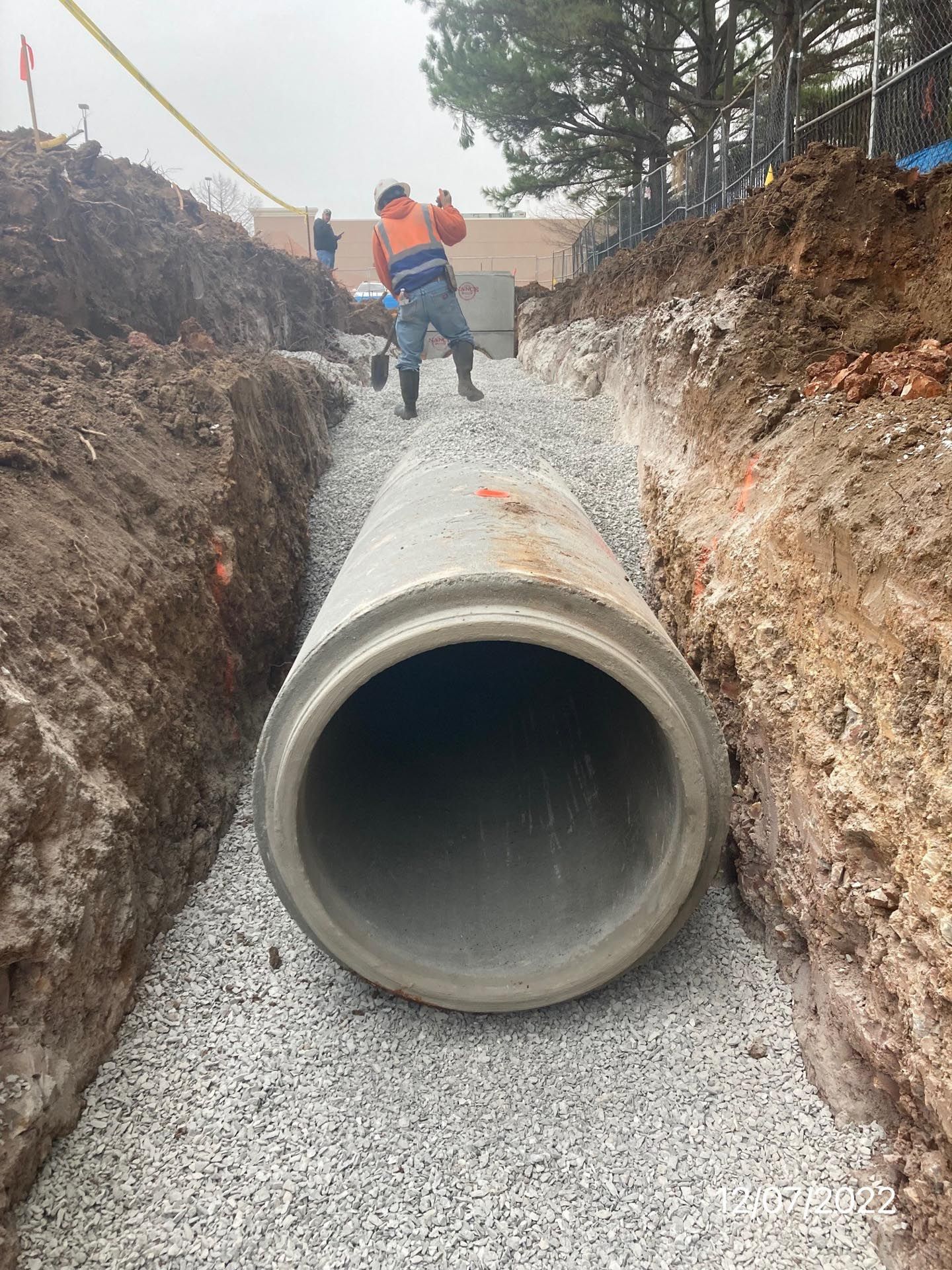 A large hole in the ground with a yellow tape around it.
