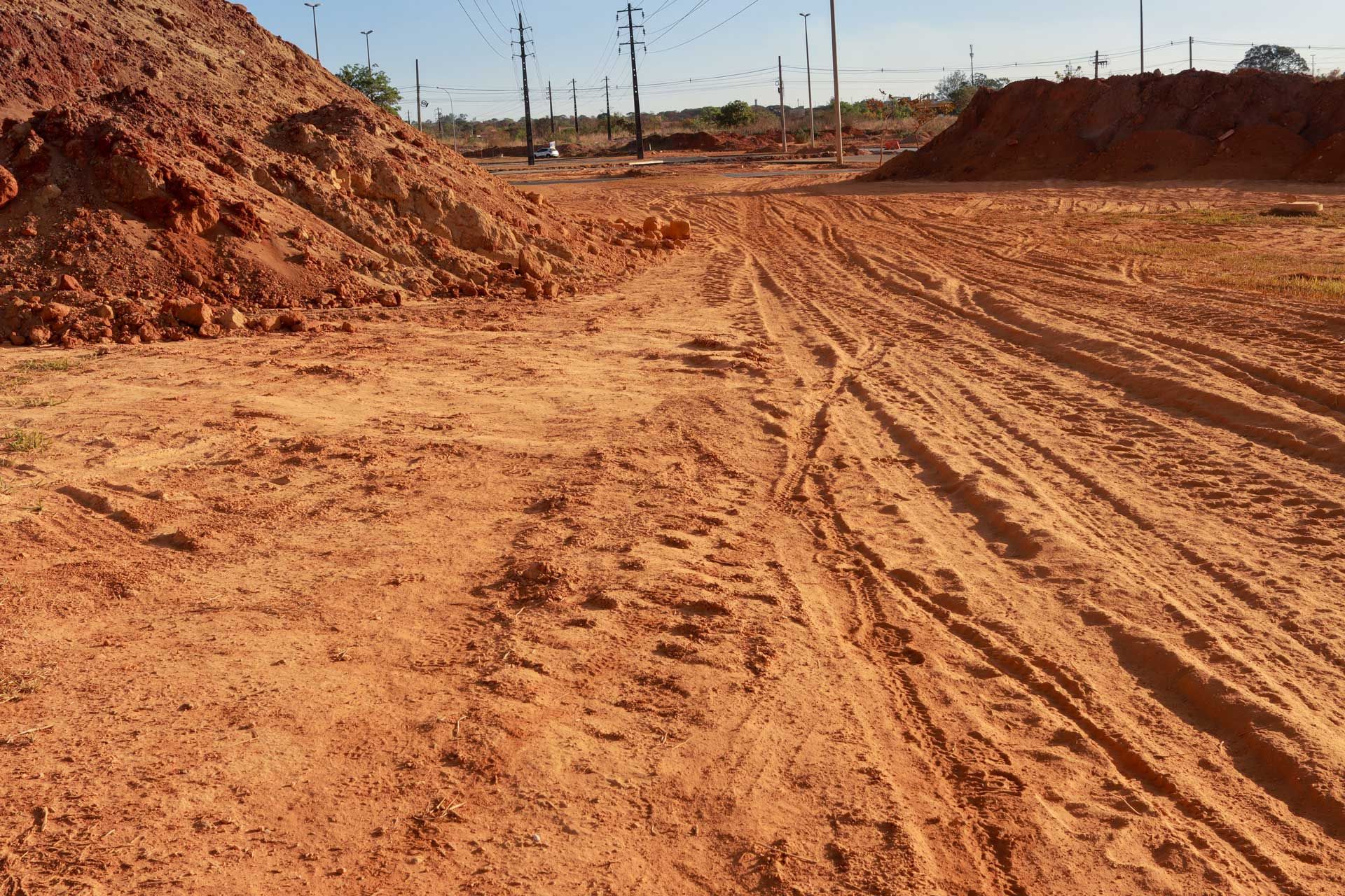 A dirt road with a pile of dirt in the background