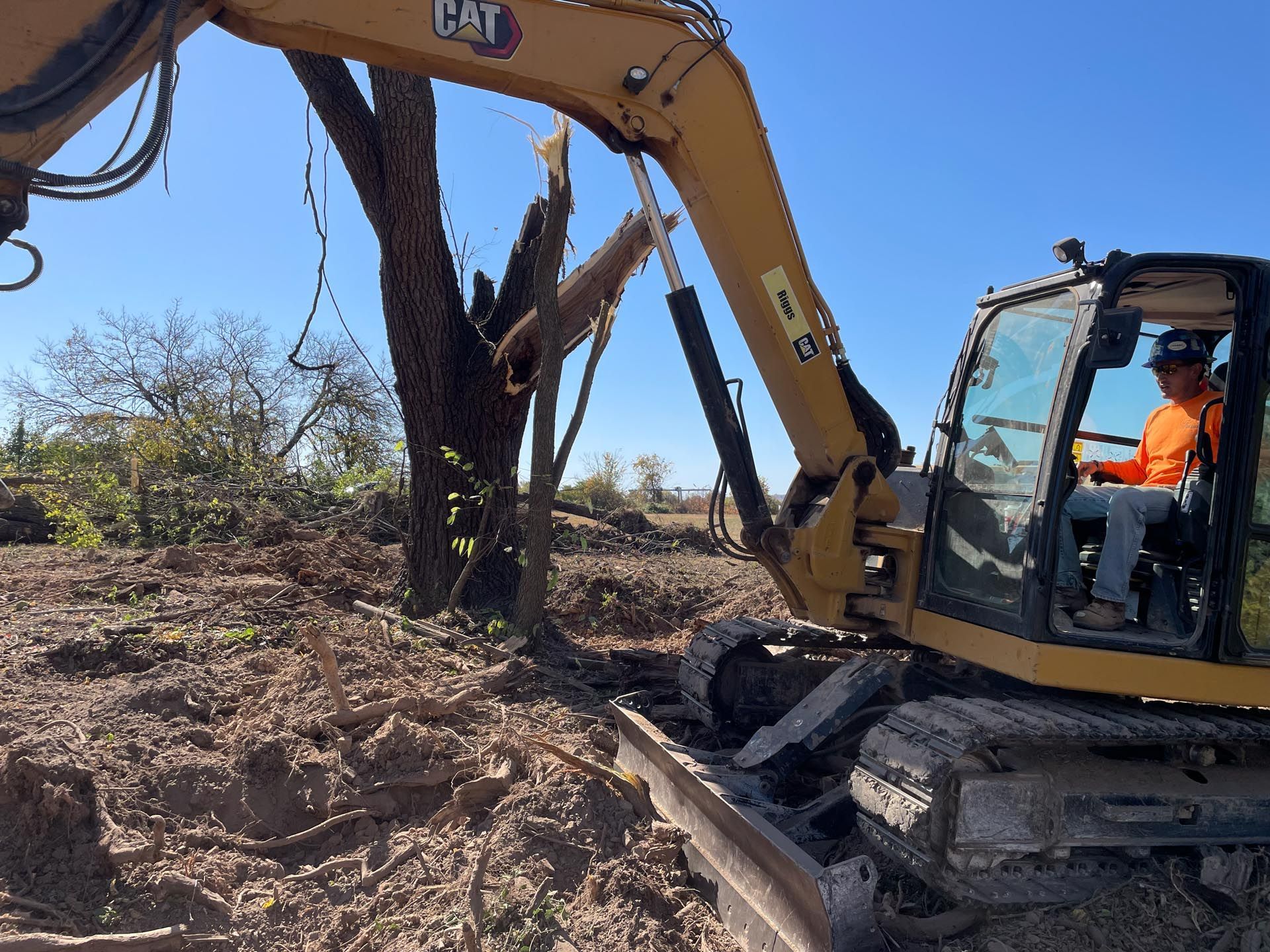 A white truck is parked on the side of the road next to a grassy field.