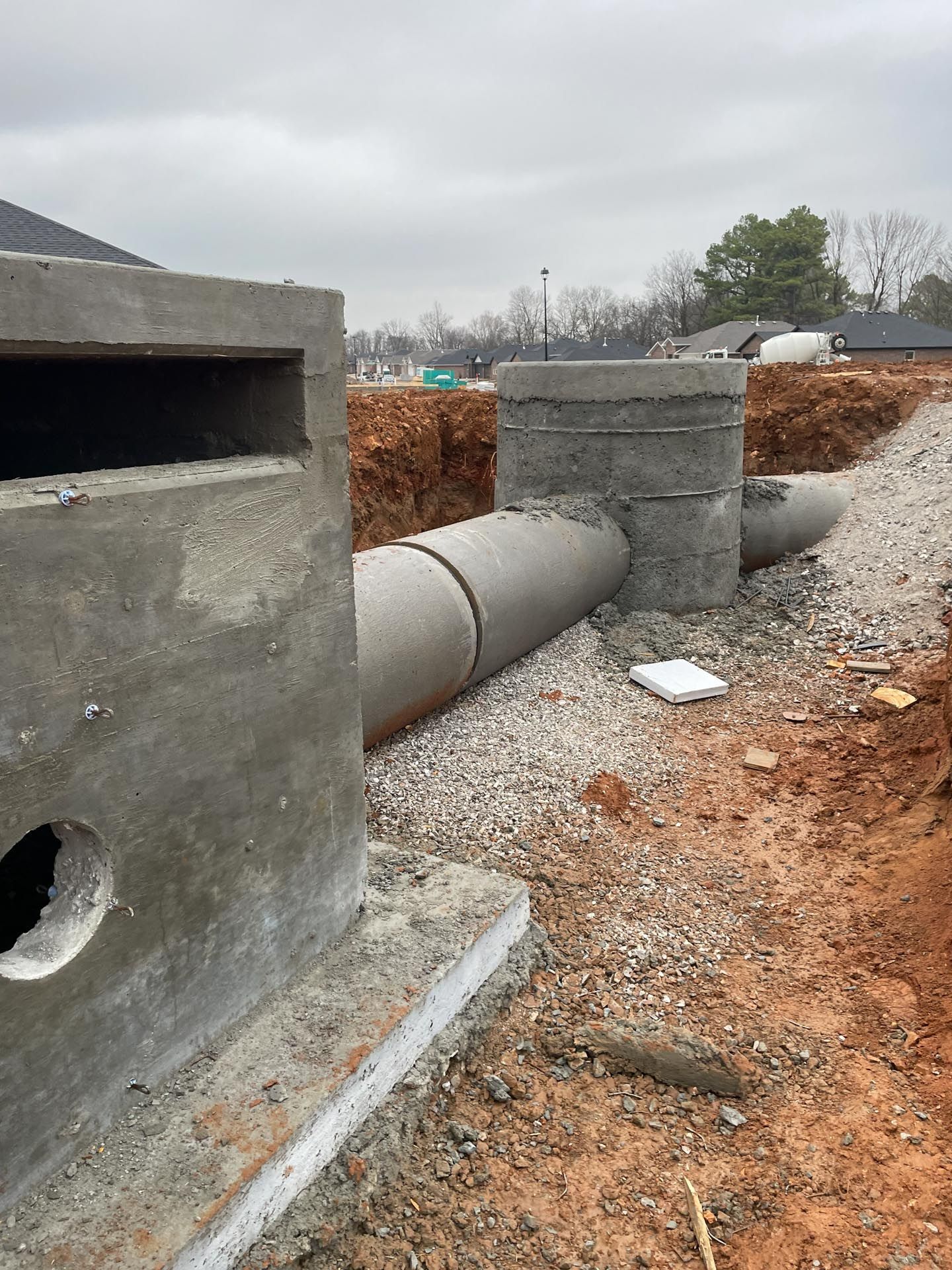 A construction site with a lot of pipes and concrete blocks.