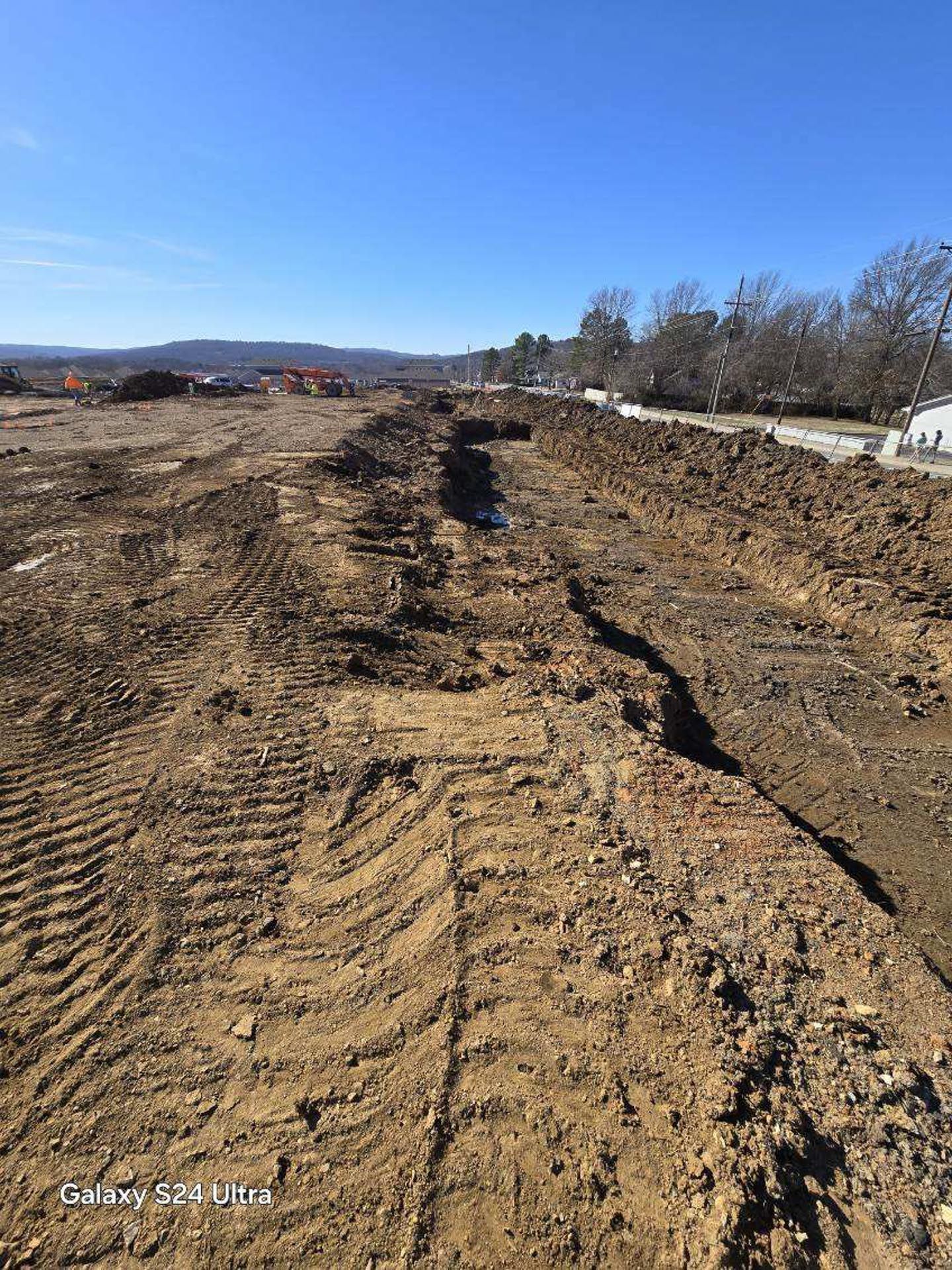 A large pile of dirt is sitting on top of a dirt field.