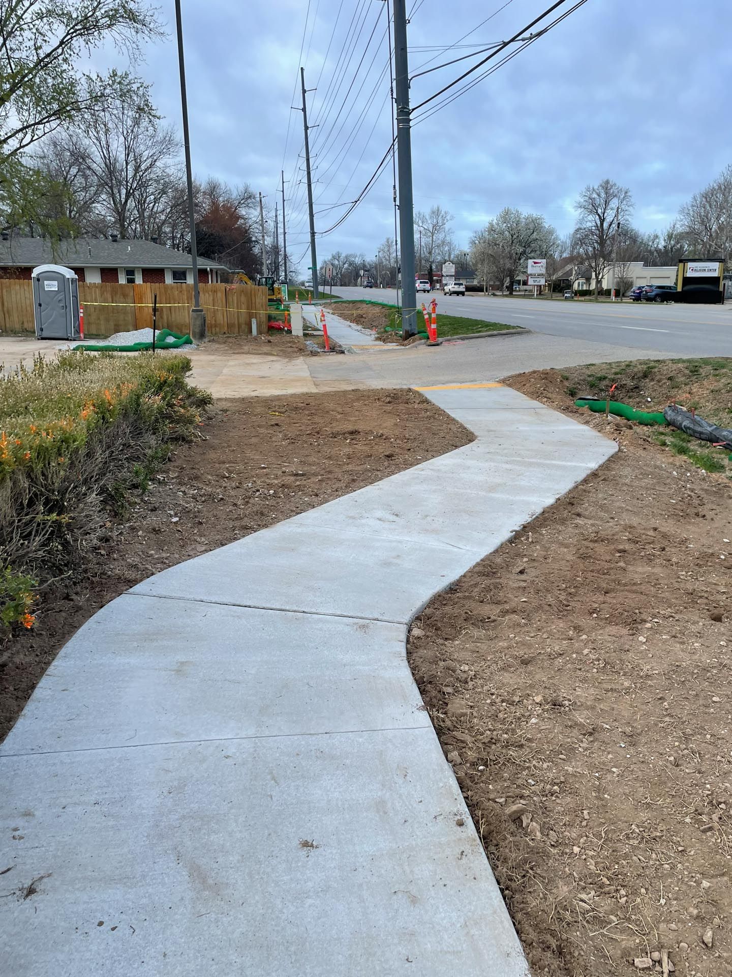 A concrete sidewalk is being built next to a road.