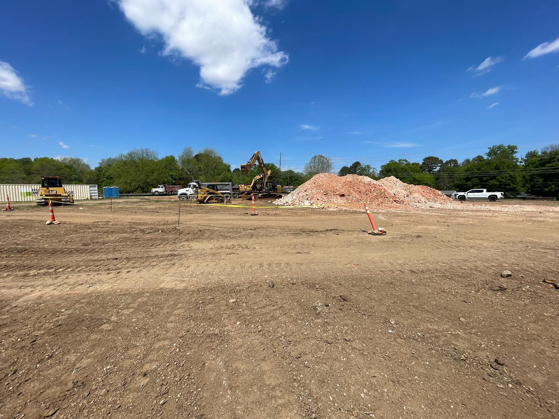 A large pile of dirt is sitting in the middle of a dirt field.