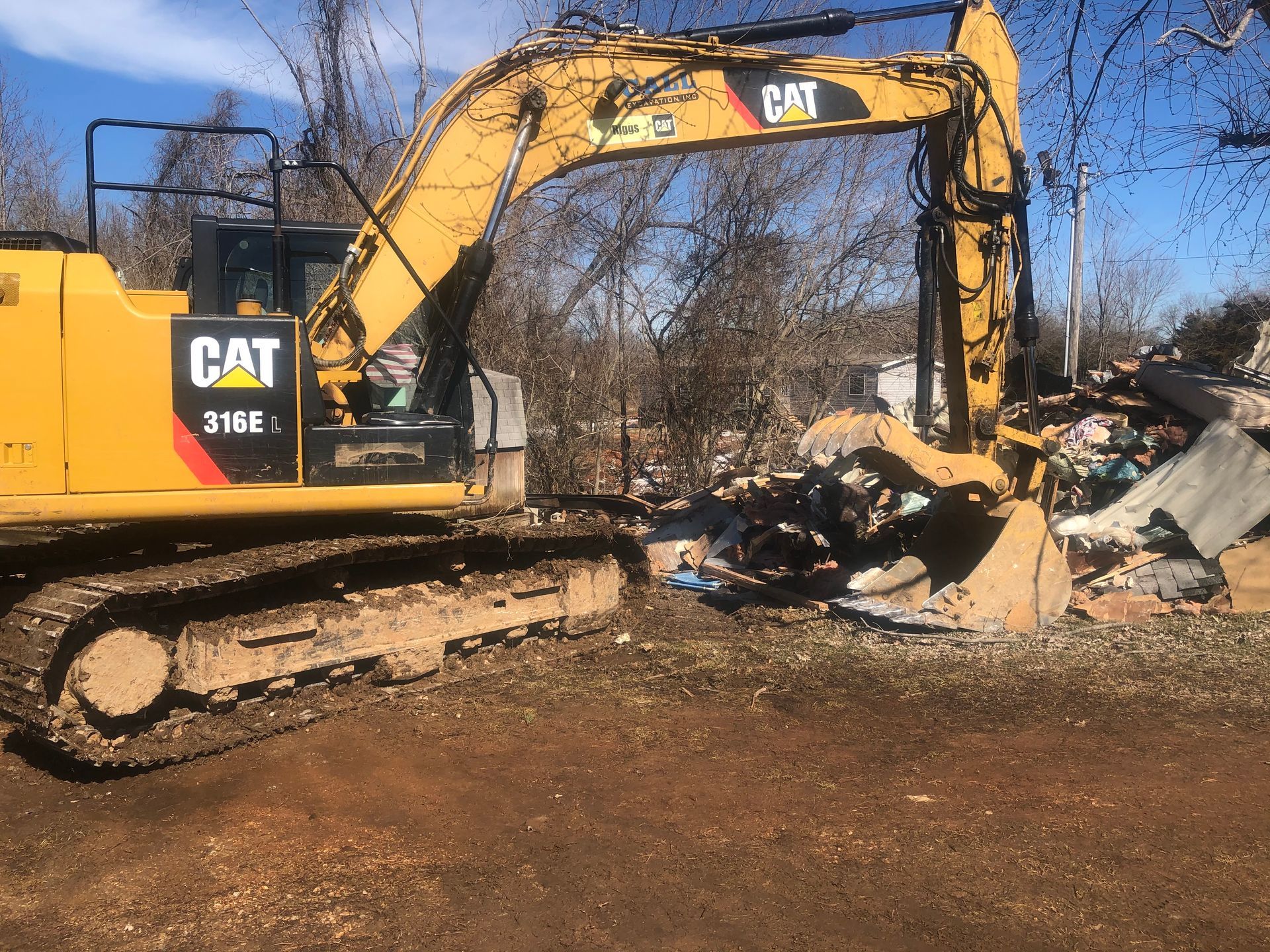 A construction site with a lot of dirt and buildings in the background.