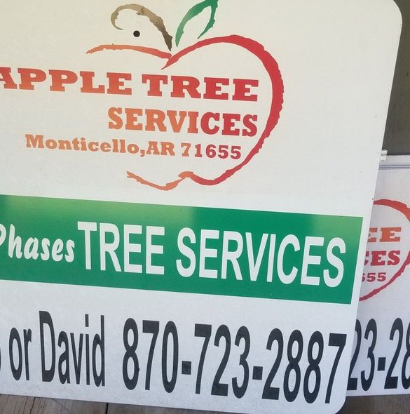 Signs for Apple Tree Services in Monticello, AR, displaying a logo and phone number. The top sign has a red apple, and the bottom sign has green text.